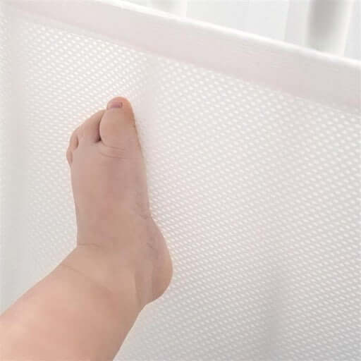 Baby Cot Bumper Half Length with a child's foot resting against the soft and breathable surface.