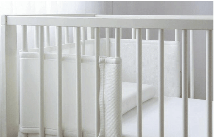 Baby Cot Bumper Half Length installed in a modern white crib, designed for safety and comfort.