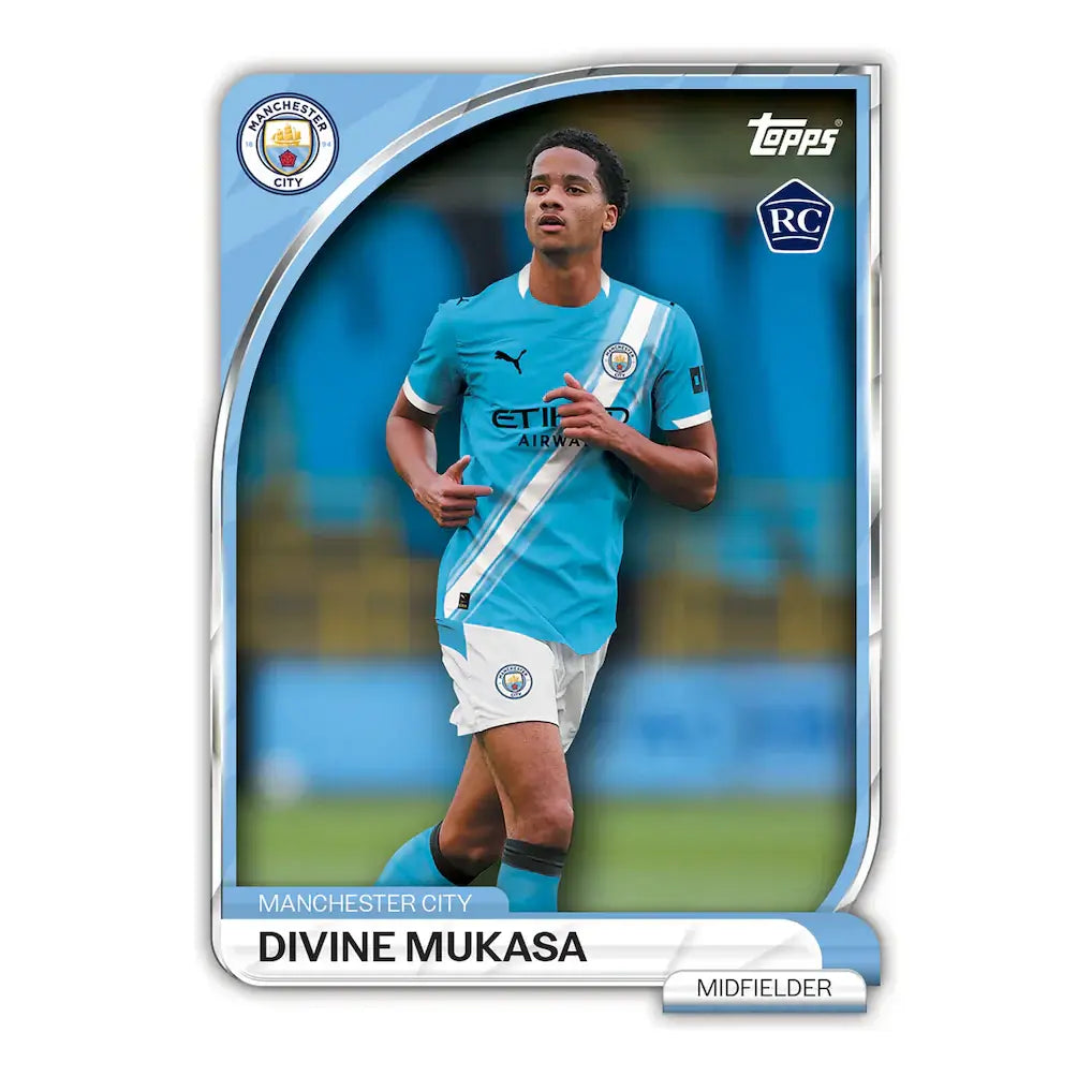 Manchester City Collectors Tin - 2025-26 featuring Divine Mukasa as a midfielder in a blue jersey.
