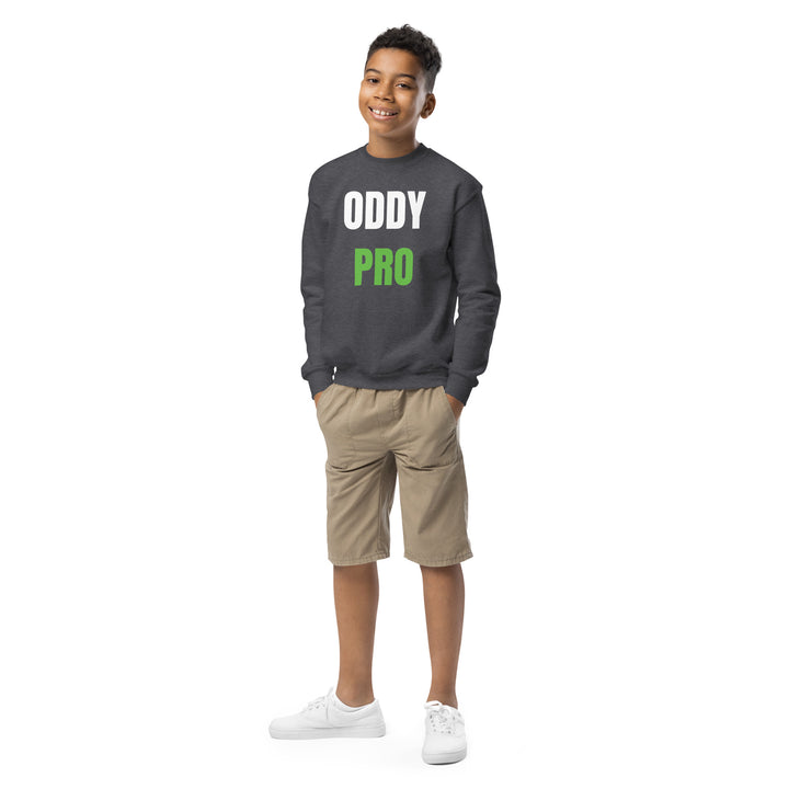 Young model wearing Oddy Pro Youth crewneck sweatshirt in grey, paired with shorts and sneakers.