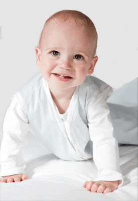 Joey Swag Baby Sleeping Bag worn by a smiling baby crawling on a bed.